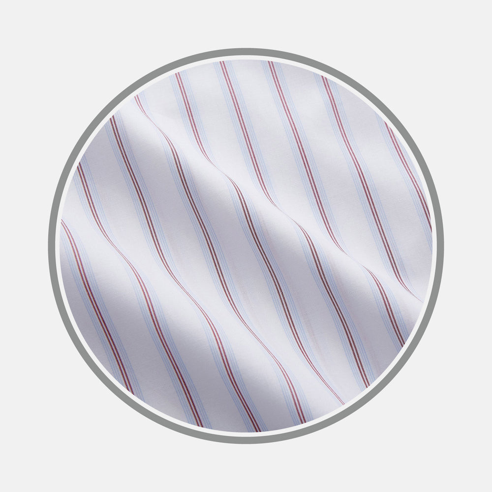 A close-up of Turnbull & Asser’s Red and Blue Multi Stripe Cotton Fabric, featuring evenly spaced thin blue and red stripes on white cotton, shown inside a circular frame on a light gray background.