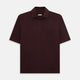The Turnbull & Asser Burgundy Polo Shirt is crafted from soft cotton jersey with short sleeves, a classic collar, three front buttons, and a small buttoned chest pocket, shown flat on a white background.