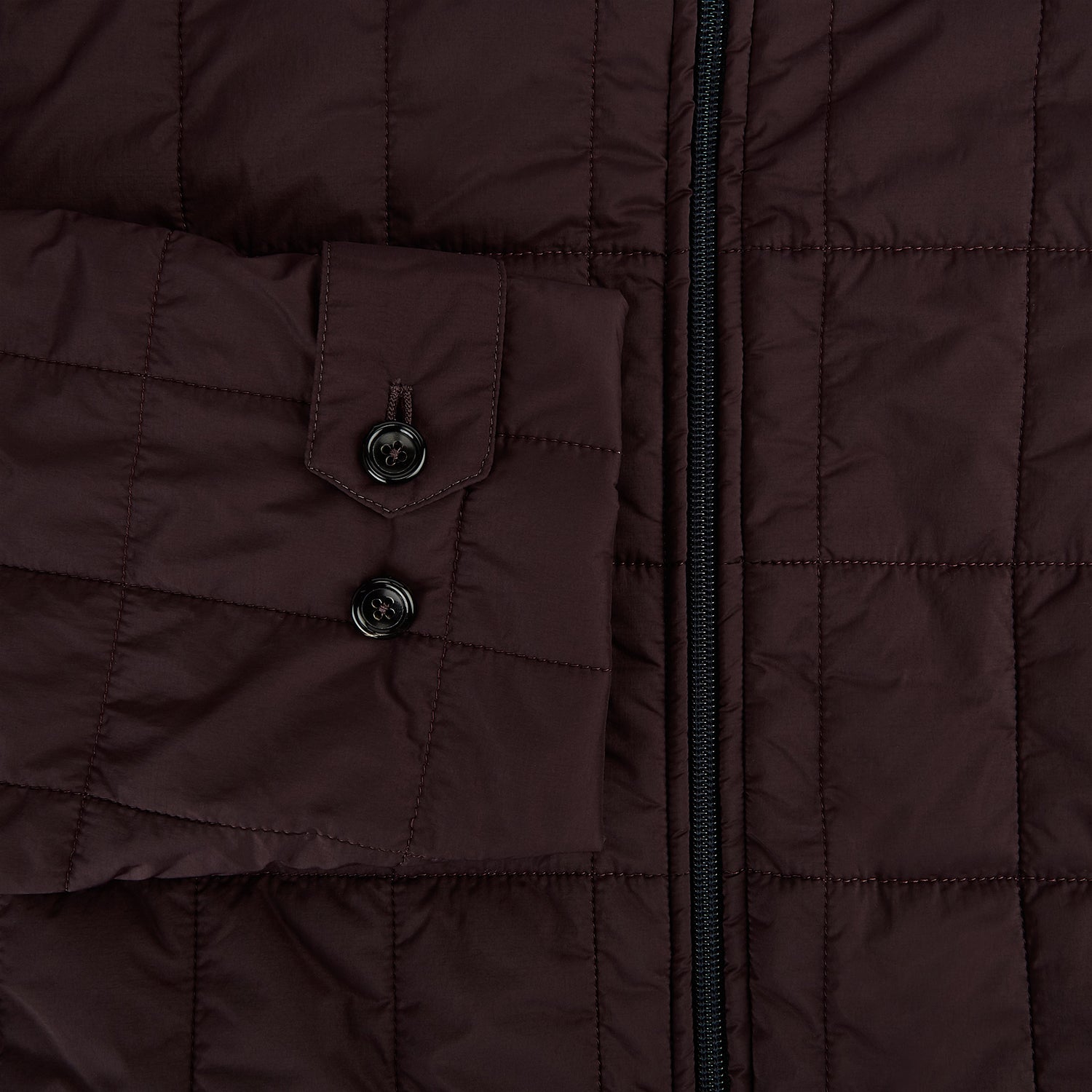View 4 of product The Battersea Burgundy Quilted Jacket by Turnbull & Asser is a men's elegant outerwear featuring a front zipper, zippered side pockets, chest pocket, pointed collar, and buttoned cuffs, shown on a plain white background.