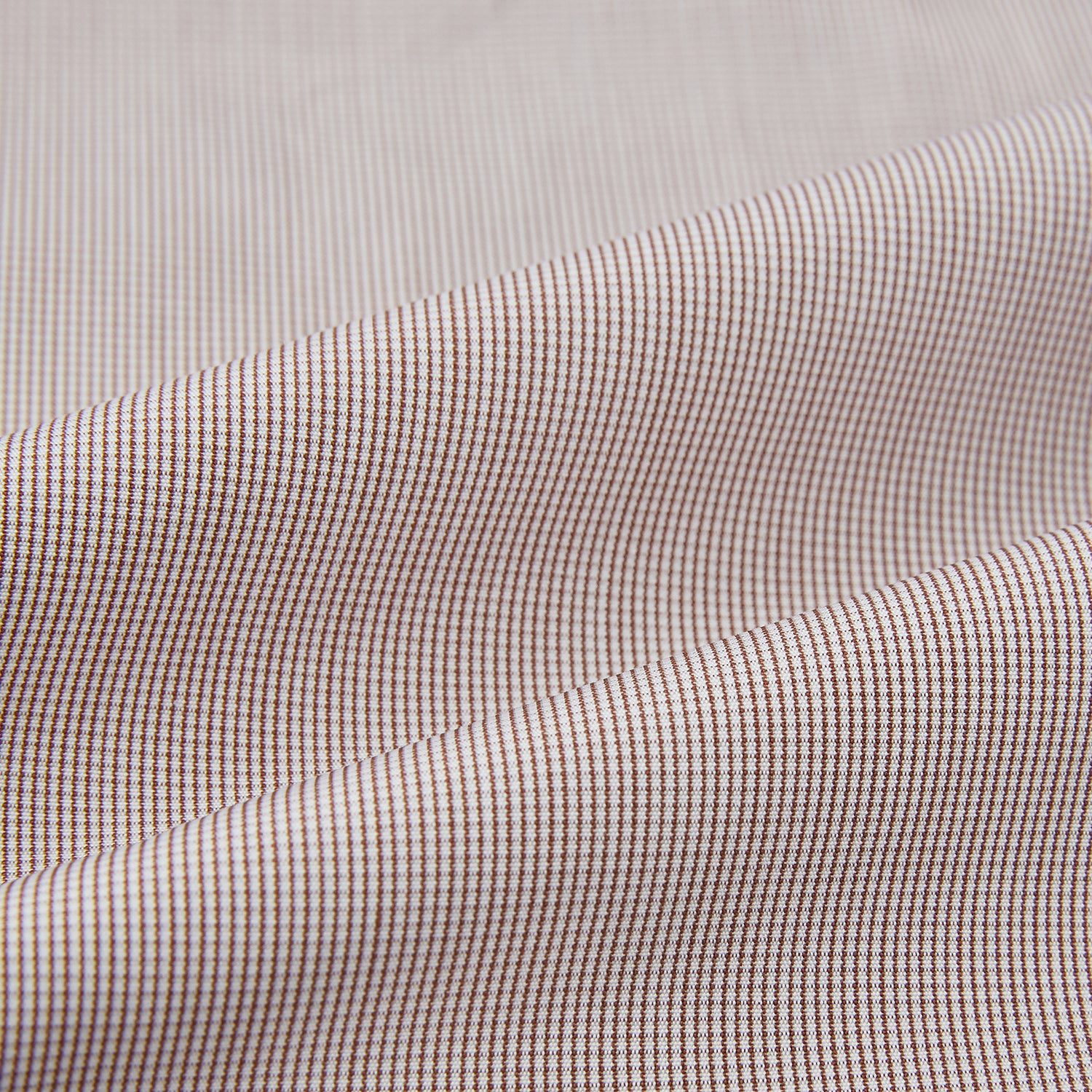 View 5 of product The Turnbull & Asser Brown Micro Check Quarzo Nightshirt is a long-sleeve shirt dress inspired by classic sleepwear, featuring a collar, chest pocket, upper front buttons, and a subtle micro check pattern on a white background.