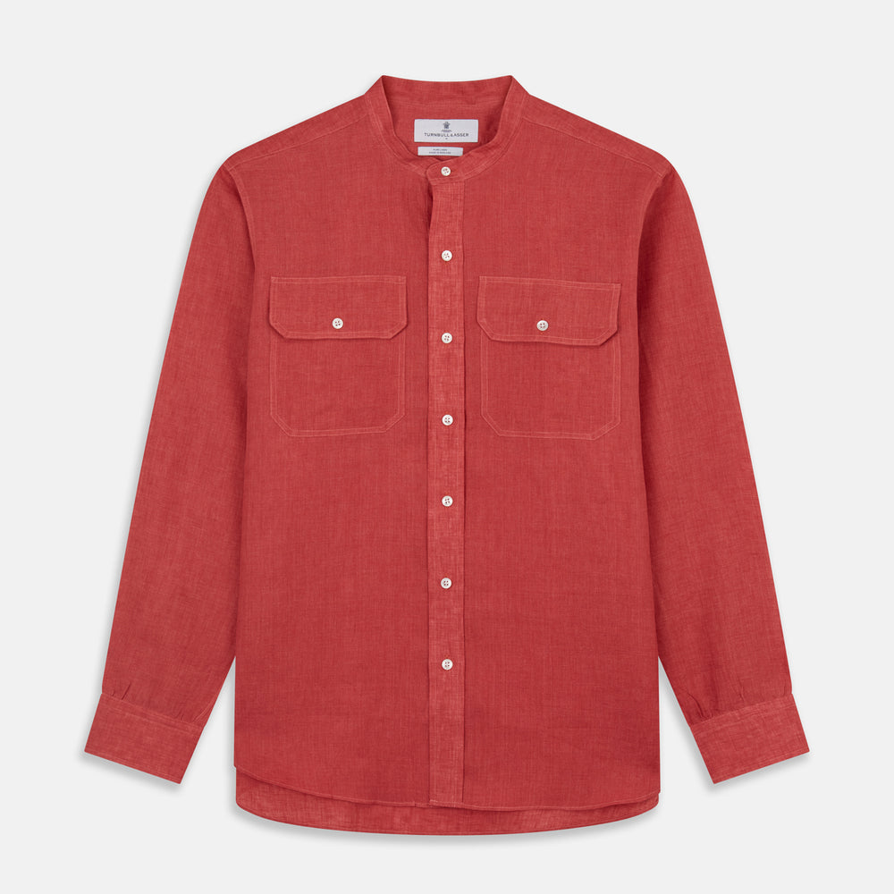 The Turnbull & Asser Plain Red Linen Weekend Fit Shirt with Stand Collar features long sleeves, a button-up front, and two buttoned-flap chest pockets. It is shown neatly laid flat on a plain light background.
