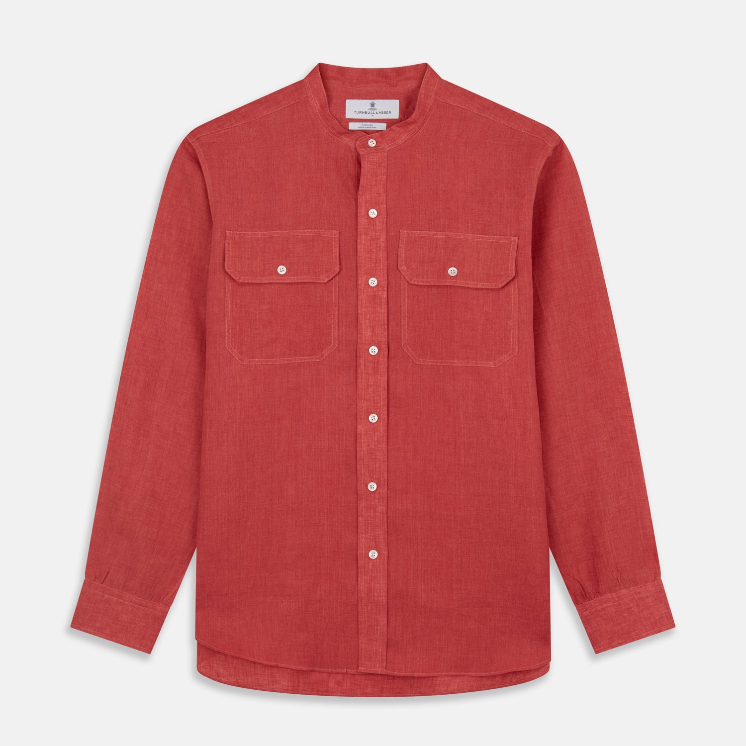View 1 of product The Turnbull & Asser Plain Red Linen Weekend Fit Shirt with Stand Collar features long sleeves, a button-up front, and two buttoned-flap chest pockets. It is shown neatly laid flat on a plain light background.