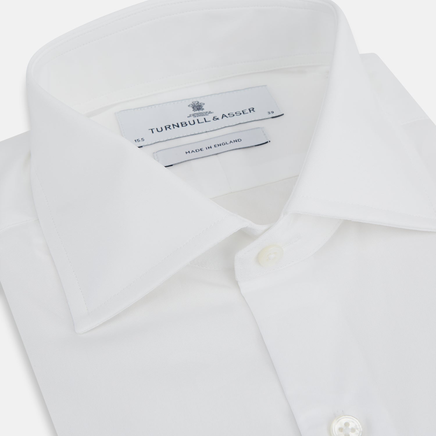 View 2 of product The Turnbull & Asser Tailored Fit Plain White Cotton Shirt features a classic kent collar and 3-button cuffs, displayed against a white background.