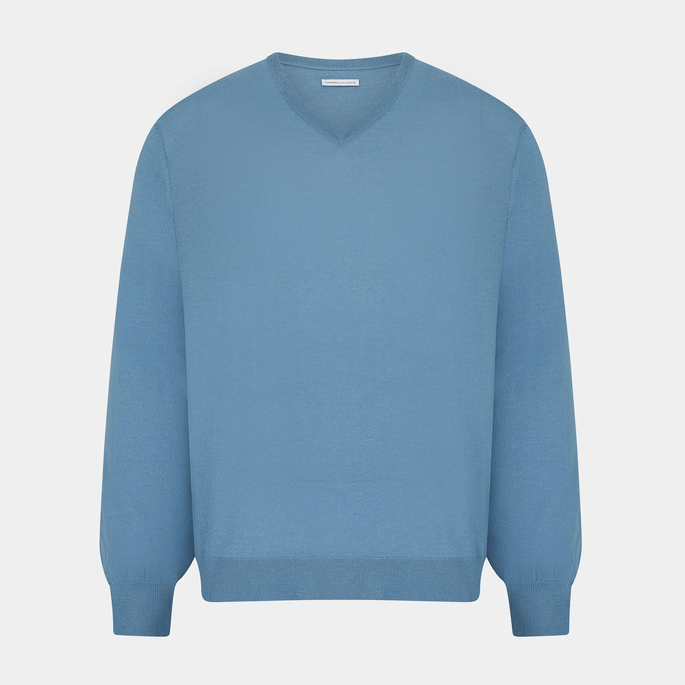 The Turnbull & Asser Pale Blue Fine Merino V-Neck Jumper features long sleeves, ribbed cuffs, and a straight hem. Shown against a white background, this classic knitwear combines comfort and style.