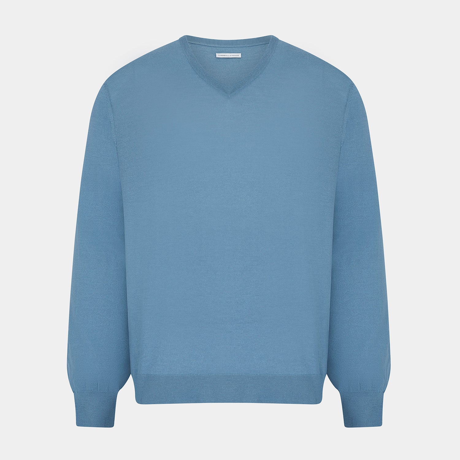 View 1 of product The Turnbull & Asser Pale Blue Fine Merino V-Neck Jumper features long sleeves, ribbed cuffs, and a straight hem. Shown against a white background, this classic knitwear combines comfort and style.