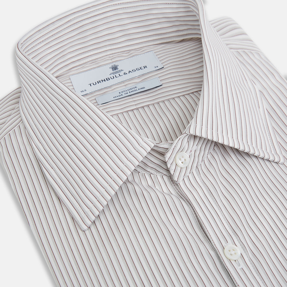 The Coffee and Grey Shadow Pinstripe Westminster Shirt by Turnbull & Asser features thin white and gray stripes, a long sleeve, button-down style, and signature collar, all reflecting classic British craftsmanship.