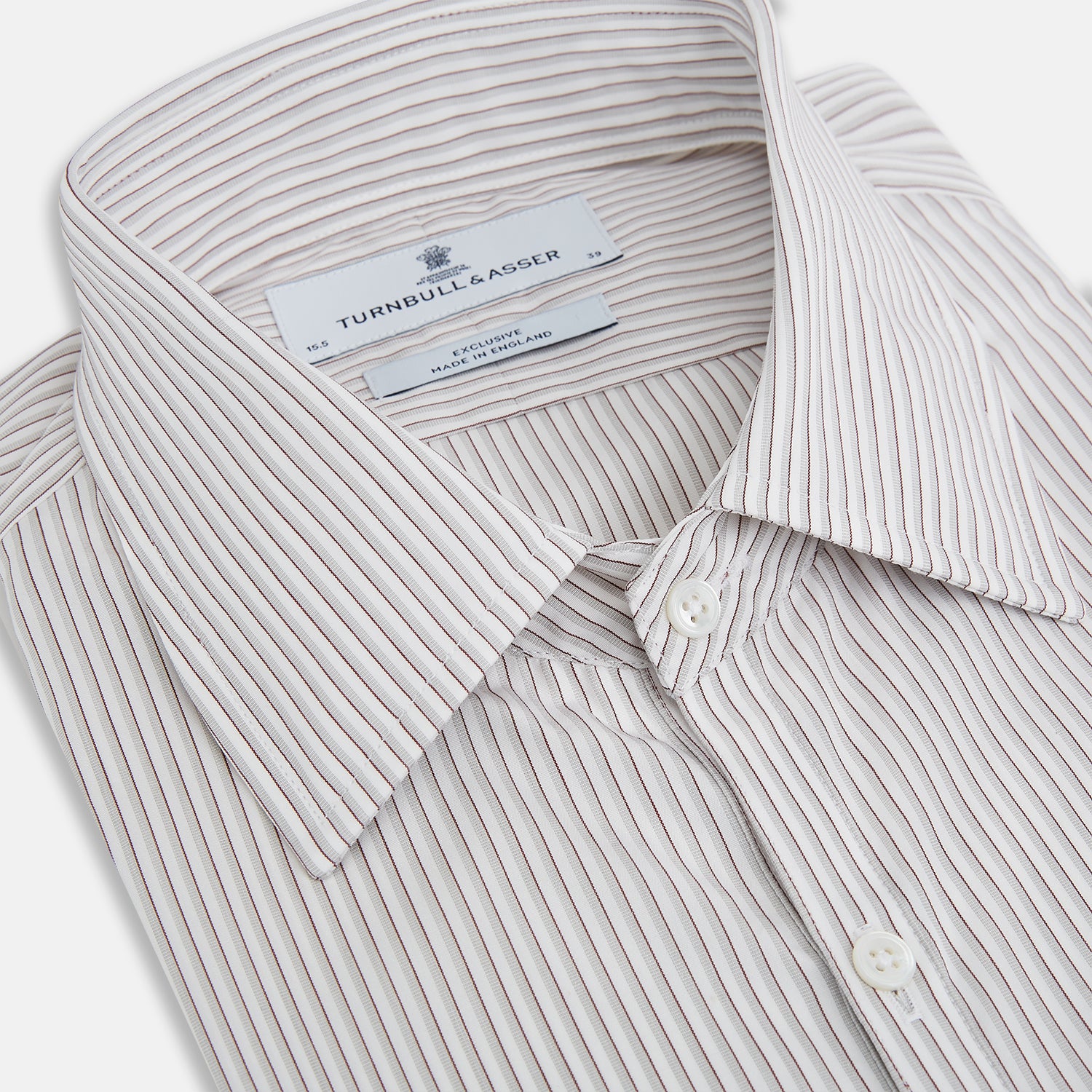 View 2 of product The Coffee and Grey Shadow Pinstripe Westminster Shirt by Turnbull & Asser features thin white and gray stripes, a long sleeve, button-down style, and signature collar, all reflecting classic British craftsmanship.