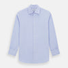 View 1 of product The Turnbull & Asser BLUE HERRINGBONE TAILORED FIT SHIRT WITH KENT COLLAR features long sleeves and buttoned cuffs, offering a timeless formal look in a classic light blue herringbone fabric, laid flat on a white background.