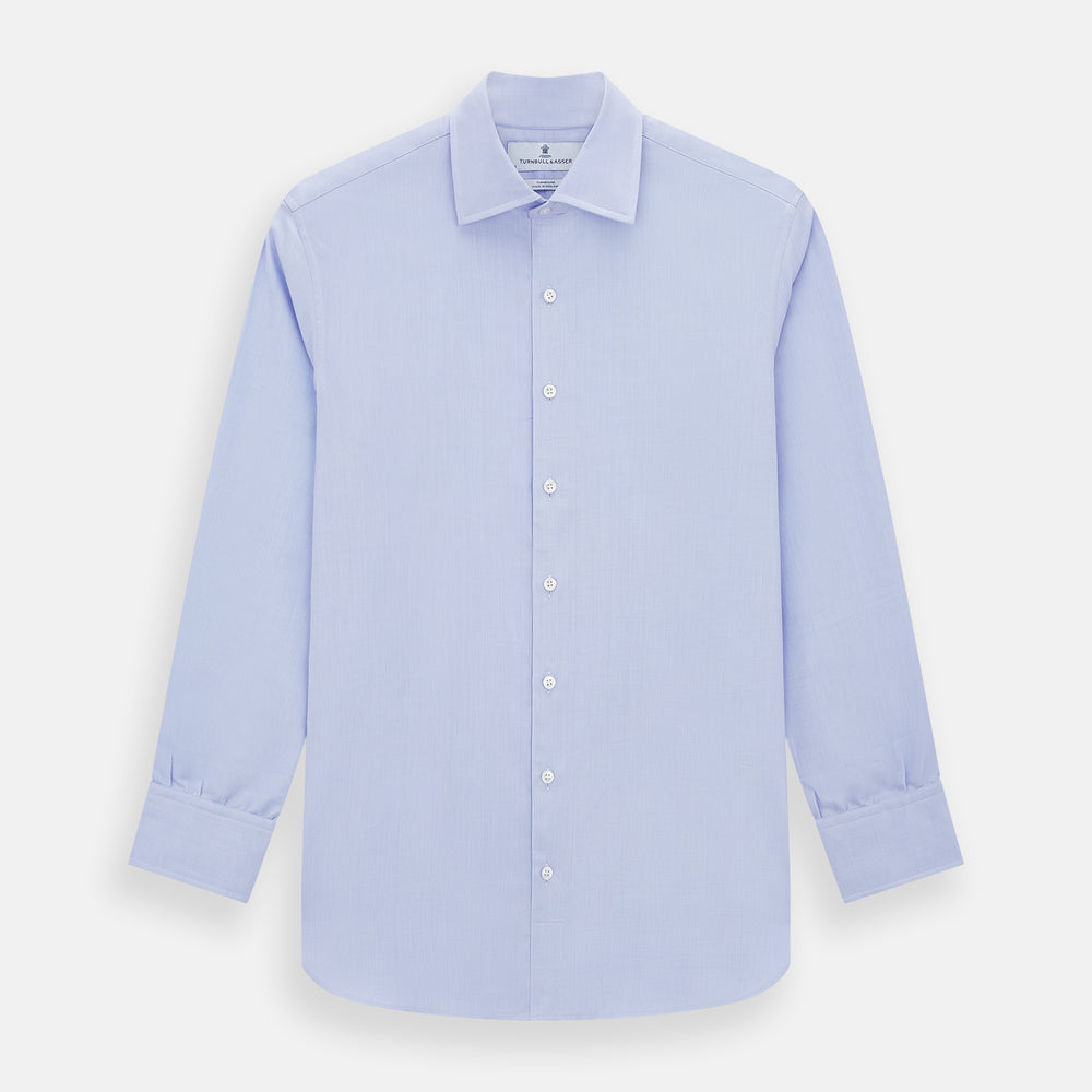 The Turnbull & Asser BLUE HERRINGBONE TAILORED FIT SHIRT WITH KENT COLLAR features long sleeves and buttoned cuffs, offering a timeless formal look in a classic light blue herringbone fabric, laid flat on a white background.