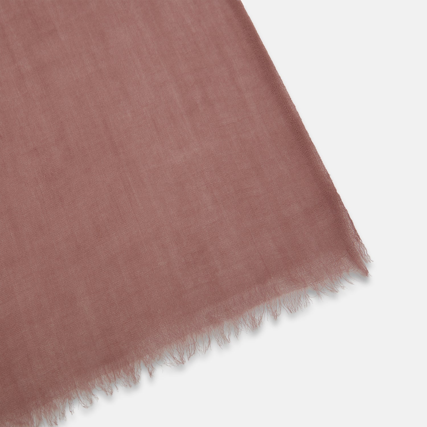 View 2 of product The Turnbull & Asser Pink Cashmere Scarf is a soft, lightweight luxury accessory with frayed edges, beautifully folded and displayed on a white background.