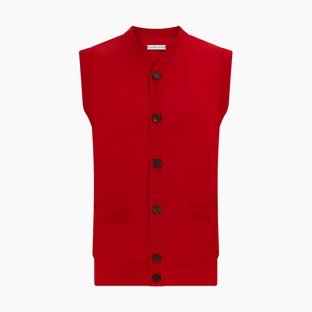 The Turnbull & Asser Red Fine Merino V-Neck Sleeveless Cardigan features a collarless neckline, two front pockets, and five dark buttons, shown on a plain white background.