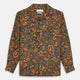 The Turnbull & Asser Khaki Green Floral Silk Holiday Fit Winnington Shirt features a bold floral print with orange, yellow, and purple on an olive background, plus a spread collar and chest pocket for versatile style.
