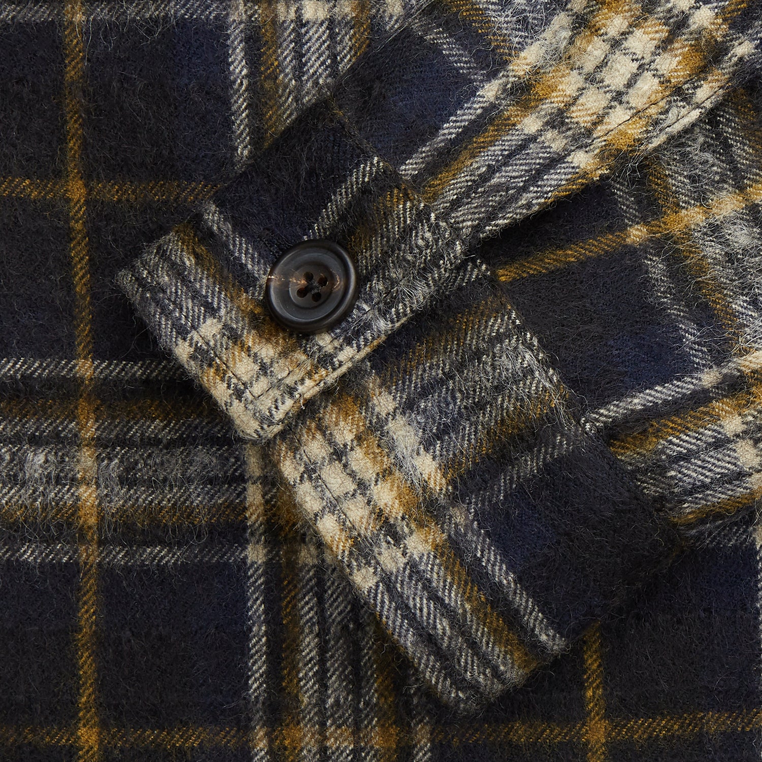View 3 of product The Turnbull & Asser Navy and Beige Check Wool and Mohair Blend Somerset Overshirt, featuring long sleeves, two chest pockets, and a classic collar, is laid flat on a white background.