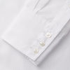 View 8 of product The White Cotton Lauren Shirt by Turnbull & Asser, featuring a stand collar, button-down front, and elongated body, is laid flat on a plain white background.