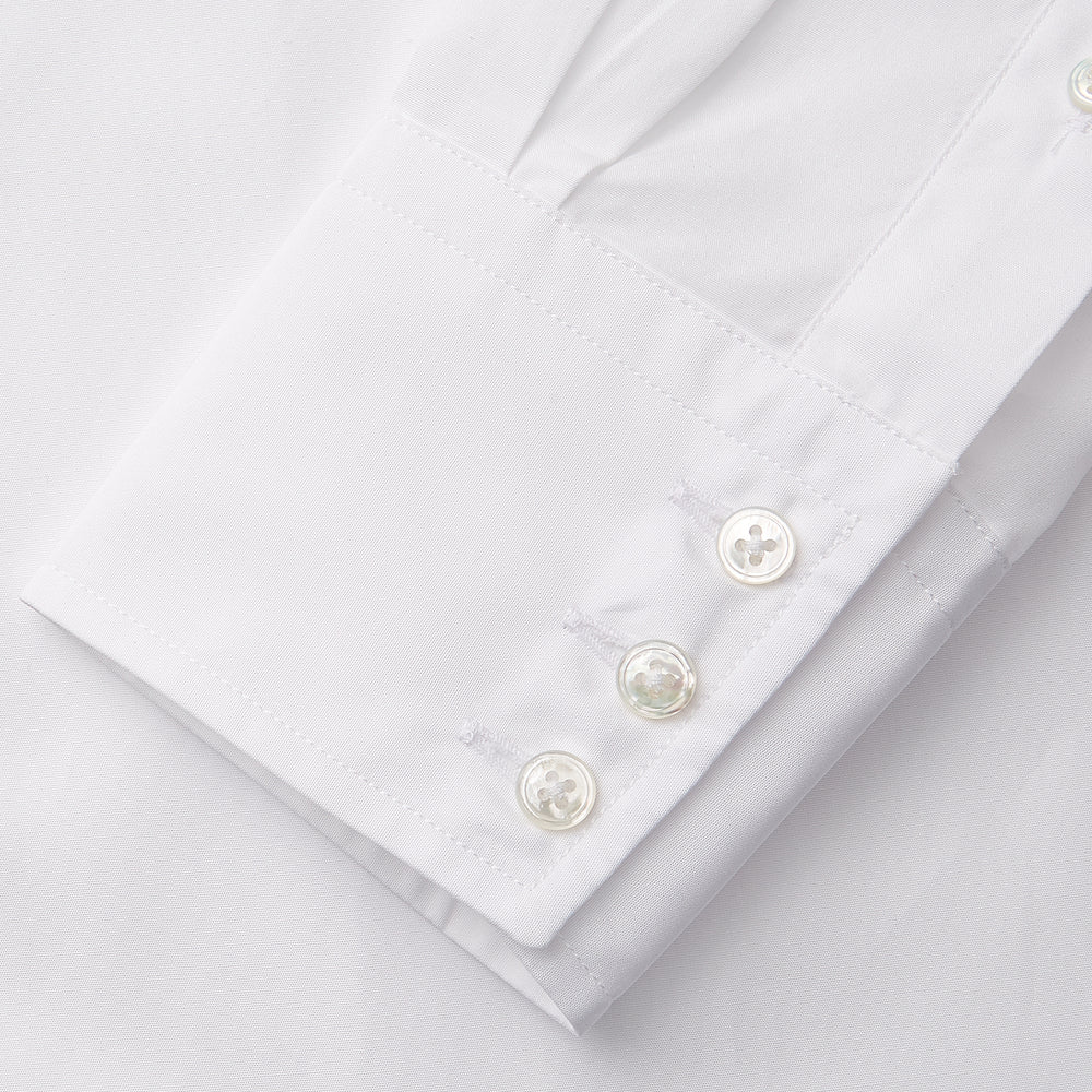 The White Cotton Lauren Shirt by Turnbull & Asser, featuring a stand collar, button-down front, and elongated body, is laid flat on a plain white background.