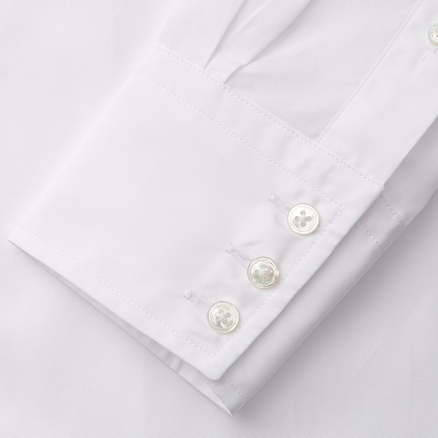 View 8 of product The White Cotton Lauren Shirt by Turnbull & Asser, featuring a stand collar, button-down front, and elongated body, is laid flat on a plain white background.