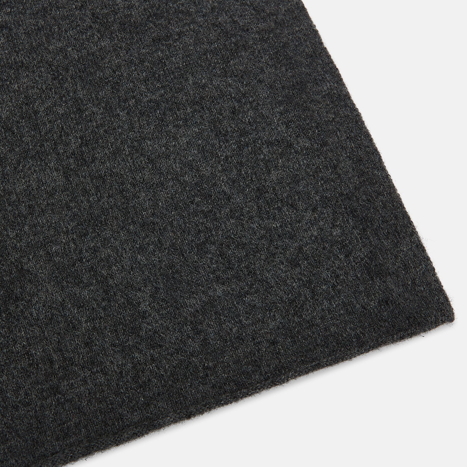 View 2 of product The Turnbull & Asser Plain Graphite Cashmere Knitted Scarf, draped and loosely knotted on a white background, showcases the refined elegance and timeless style of a luxury accessory.