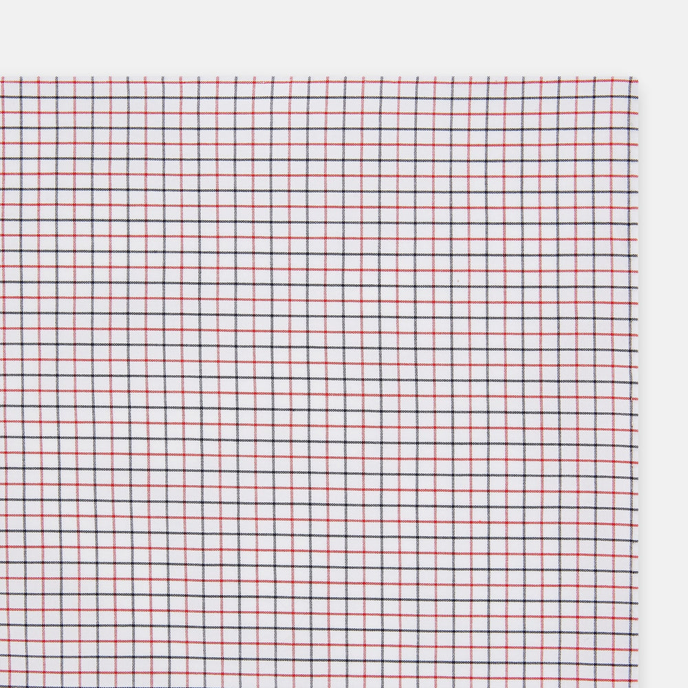 Turnbull & Asser’s Hand Rolled Red and Navy Graph Check Handkerchief—a white cotton accessory with red and navy grid lines, neatly folded for a touch of refined elegance.