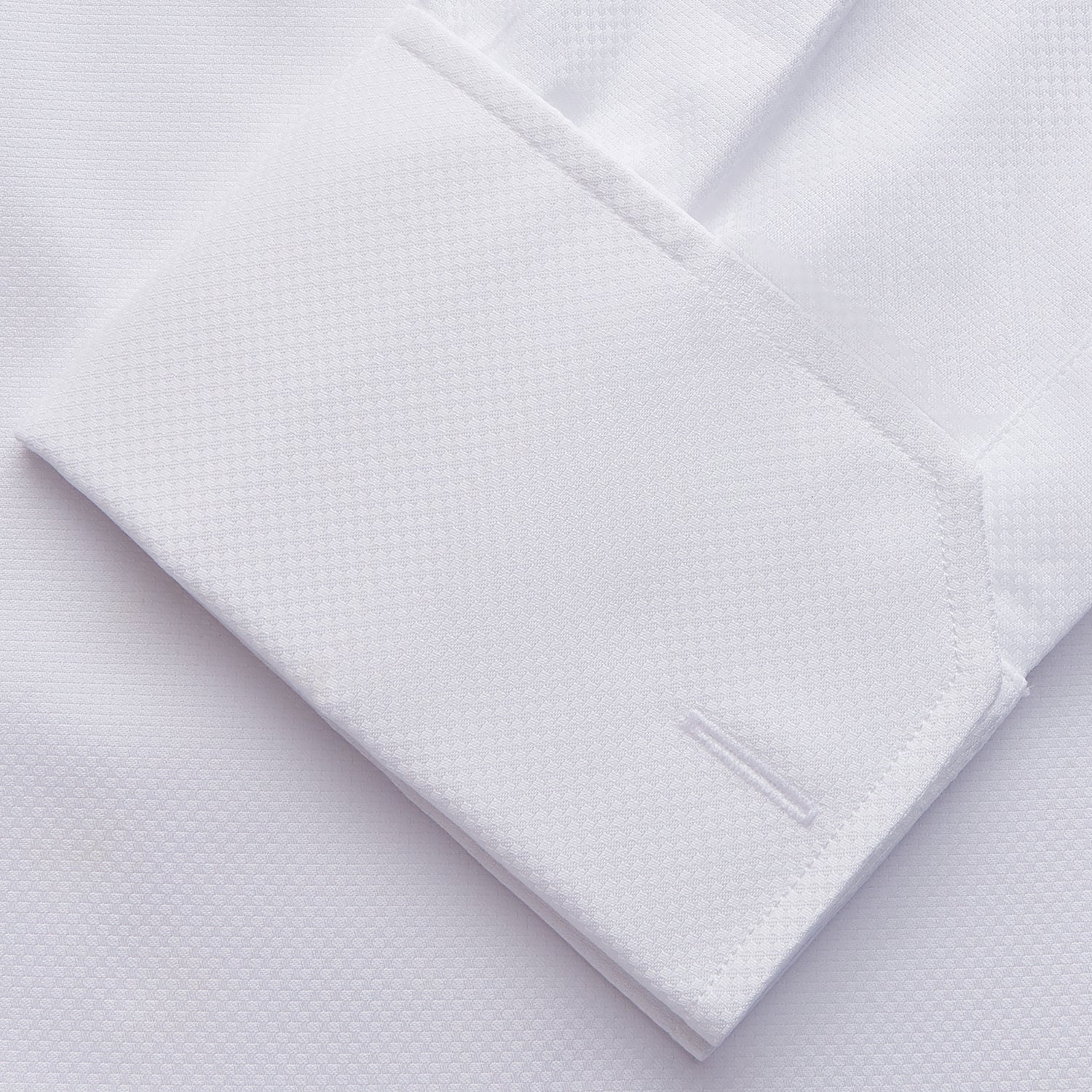 View 3 of product The Turnbull & Asser WHITE TAILORED FIT DRESS SHIRT features a pointed collar, buttoned cuffs, and a concealed button placket, shown on a plain white background.