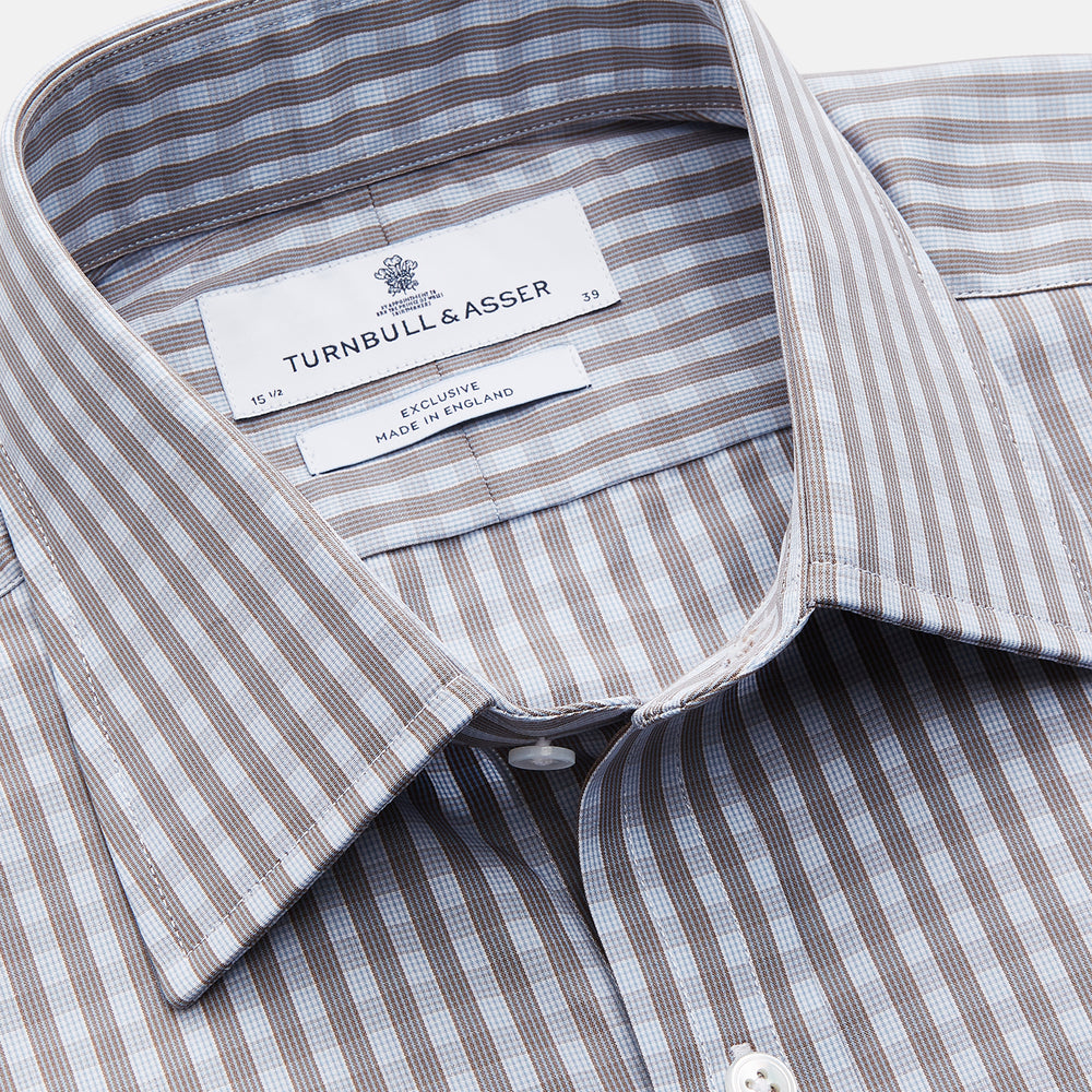 The Turnbull & Asser Pale Blue Multi Check Cotton Regular Fit Mayfair Shirt features a pale blue checkered pattern and long sleeves, shown on a white background.