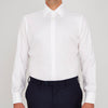 View 2 of product A neatly folded Turnbull & Asser White Oxford Shirt with T&A collar and double cuffs is displayed on a light blue background.