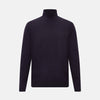 View 1 of product The Turnbull & Asser Dark Purple Fine Merino High Neck Jumper is shown against a white background. This classic sweater features a fitted collar and a simple, timeless design with no visible patterns or logos.