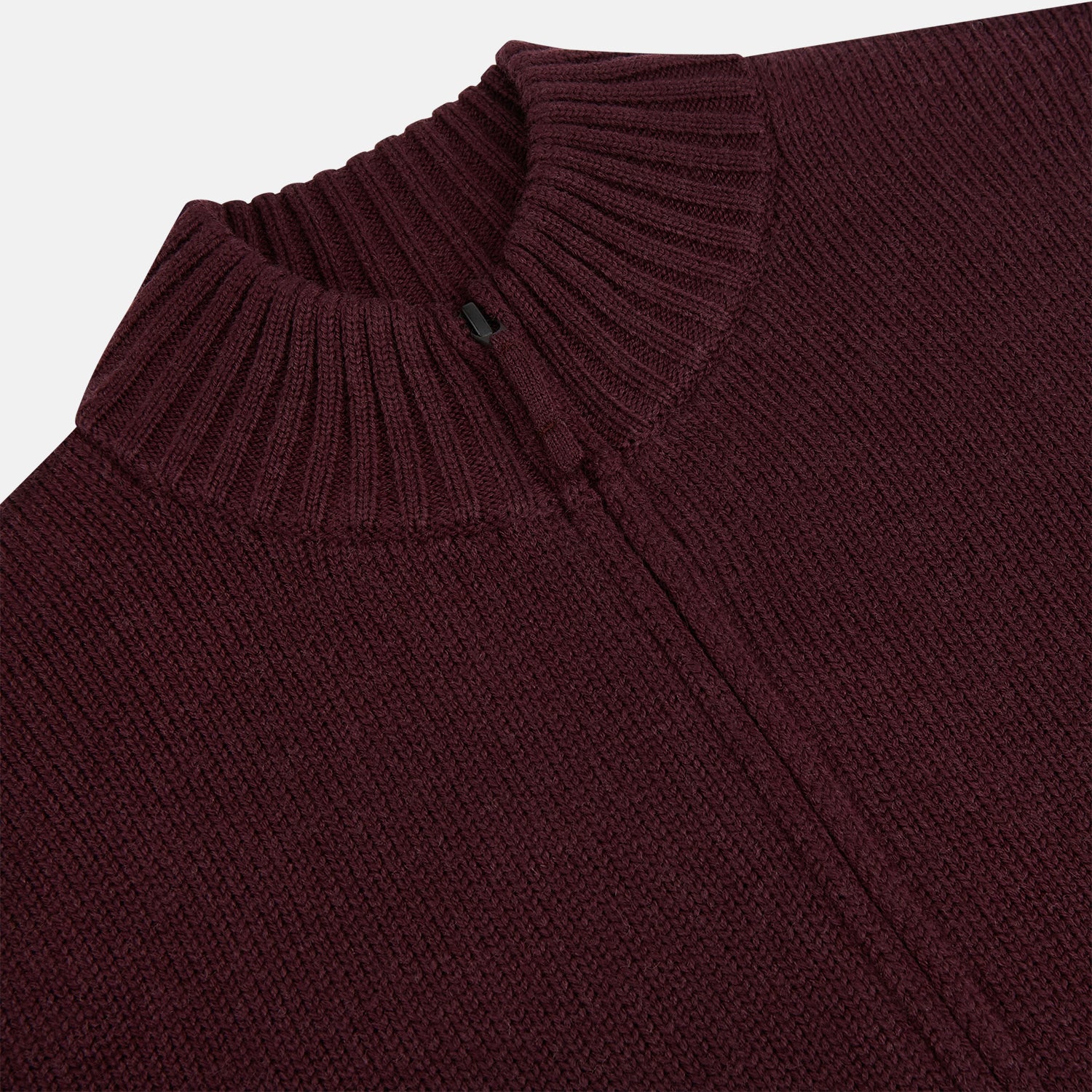 View 2 of product The Turnbull & Asser Burgundy Merino High Neck Zipped Cardigan features long sleeves, a zip-up front, and ribbed collar, cuffs, and hem, crafted from soft merino knitwear and shown on a white background.