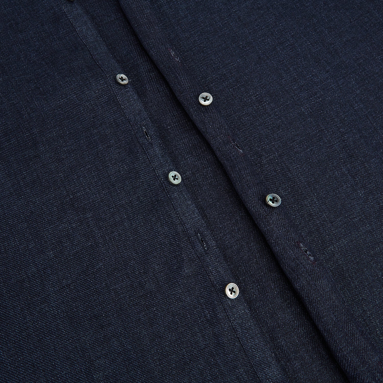 View 7 of product The Navy Linen Windsor Shirt by Turnbull & Asser features long sleeves, white buttons, a Turnbull collar, and buttoned cuffs in dark navy blue linen. Shown laid flat on a white background.