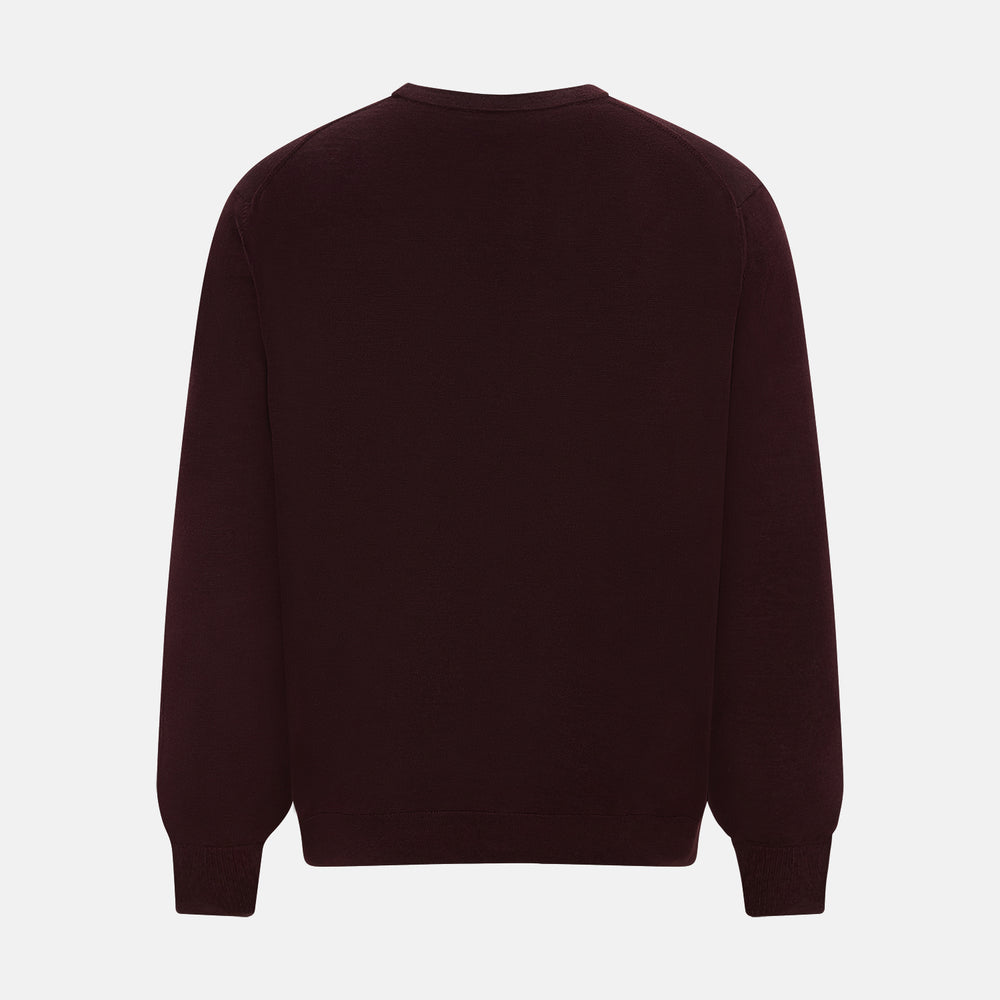 The Turnbull & Asser Burgundy Fine Merino V-Neck Cardigan features long sleeves and a button-down front, highlighting elegant handcrafted knitwear against a plain white background.