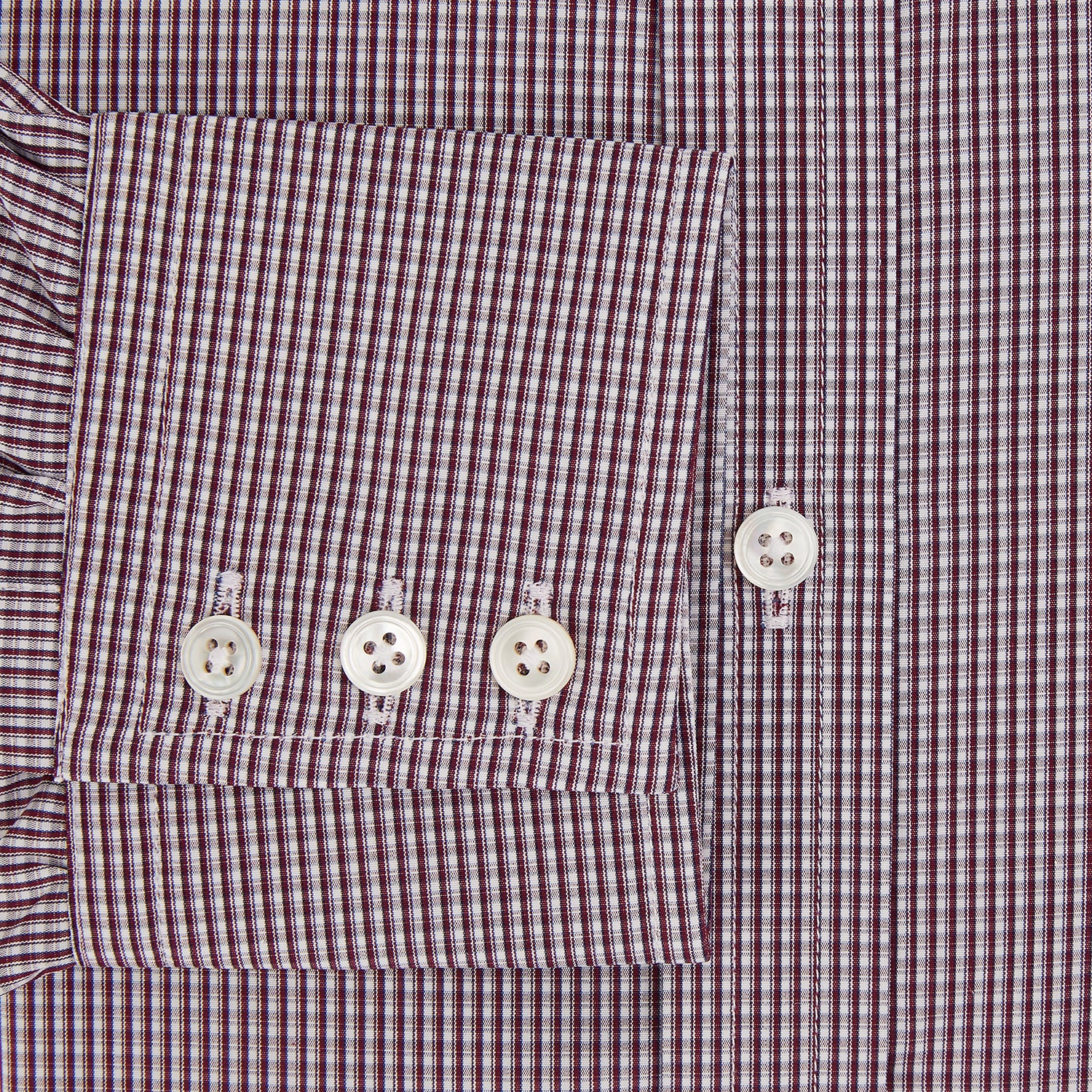 View 4 of product The Turnbull & Asser Burgundy Micro Check Mayfair Shirt features long sleeves, a pointed collar, and white buttons—perfect for formal wear. Shown laid flat on a white background.