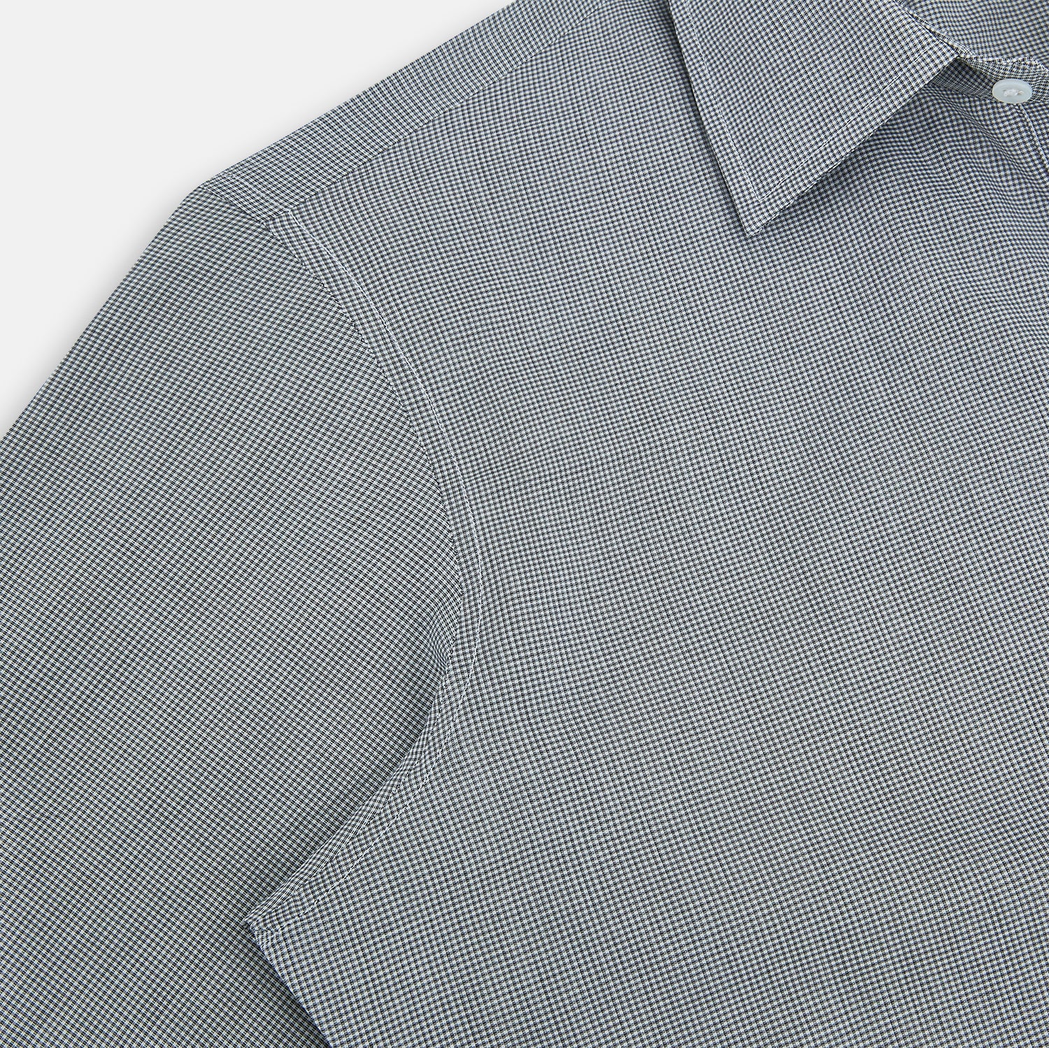 View 5 of product The Turnbull & Asser Grey and White Micro Check Westminster Shirt features long sleeves, a button-up front, a Westminster collar, and white buttons, shown flat on a white background.