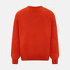 View 3 of product The Turnbull & Asser Red Orange Cashmere V-neck Jumper features long sleeves, ribbed cuffs and hem, displayed on a plain white background—a stylish knitwear essential for any wardrobe.