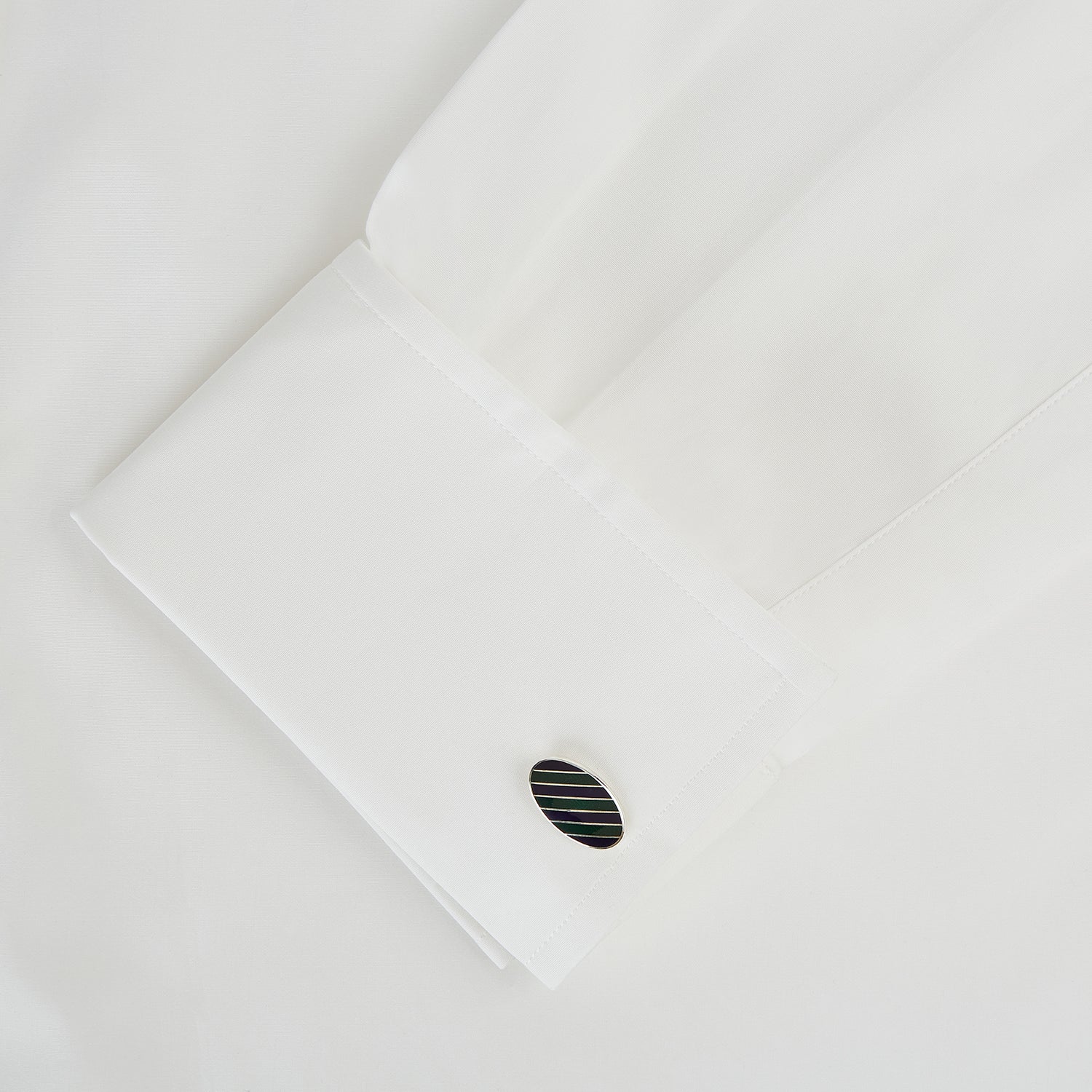 View 3 of product The Forest Green and Navy Striped Oval Enamel Cufflinks by Turnbull & Asser feature artisanal craftsmanship and a bold, masculine design, with elegant stripes set on a classic silver finish against a sophisticated white backdrop.
