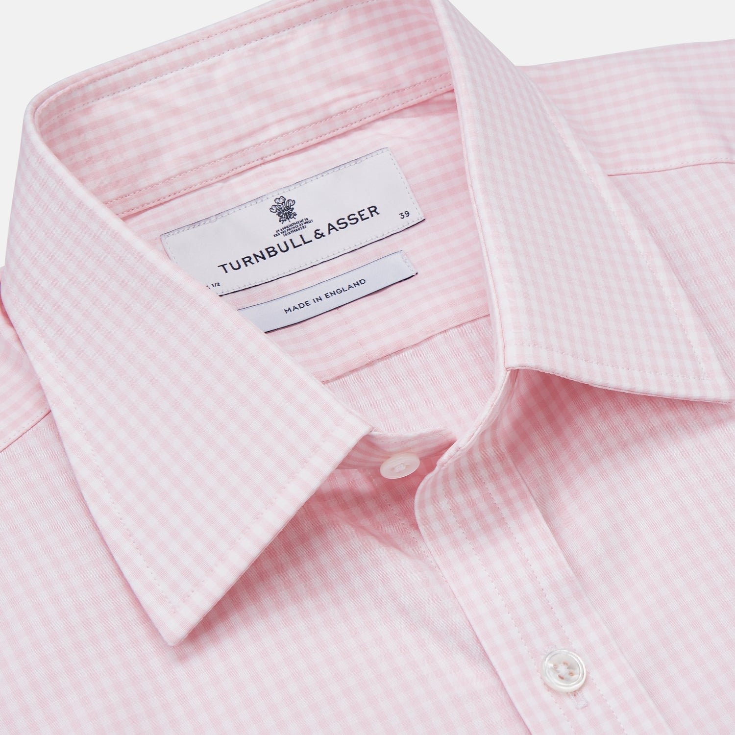View 2 of product The Pink Windowpane Check Mayfair Shirt by Turnbull & Asser features a light pink, long-sleeve design with subtle windowpane checks, button-down front, and soft organic cotton, shown against a white background.