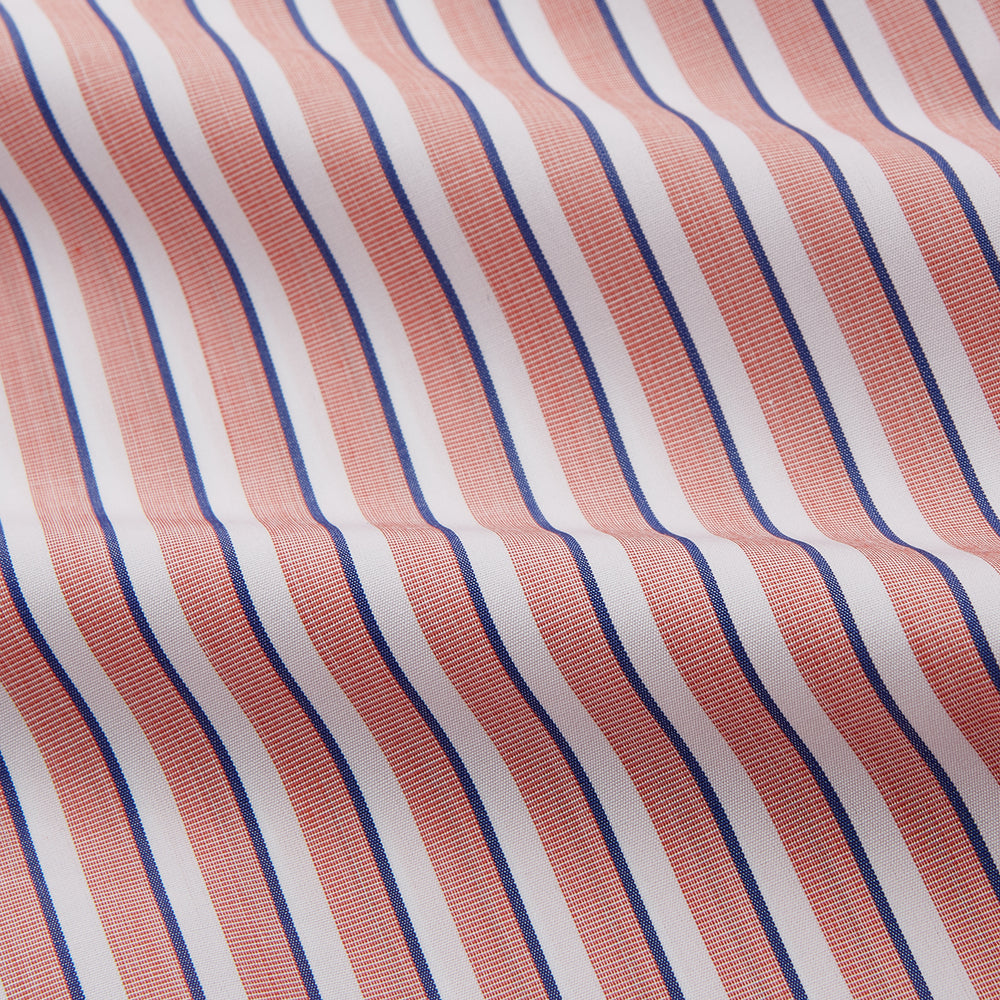 The Turnbull & Asser Orange and White Stripe Cotton Regular Fit Mayfair Shirt features vertical stripes, a classic collar, and buttoned cuffs—an essential men’s wardrobe piece, shown laid flat on a white background.
