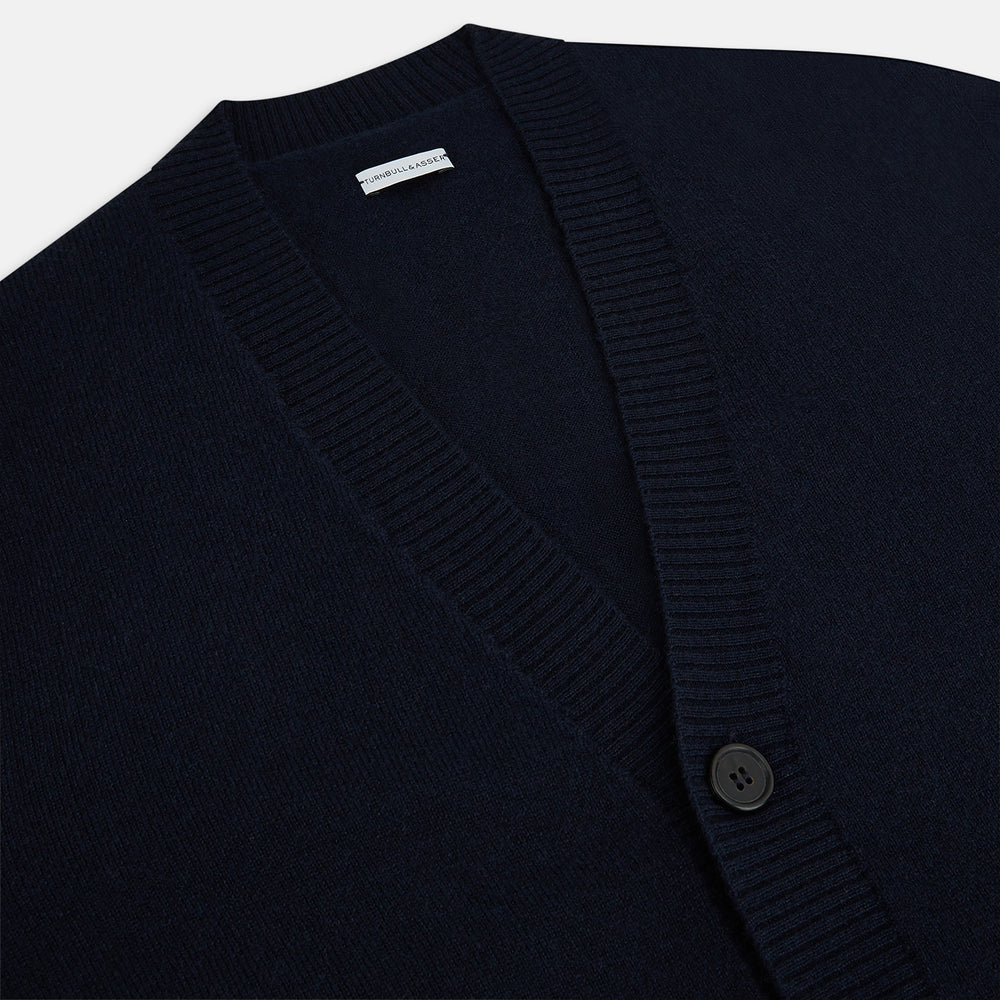 The Navy V-Neck Cashmere Cardigan by Turnbull & Asser features a button-up front, ribbed cuffs and hem, and two front pockets—a classic from our knitwear collection.