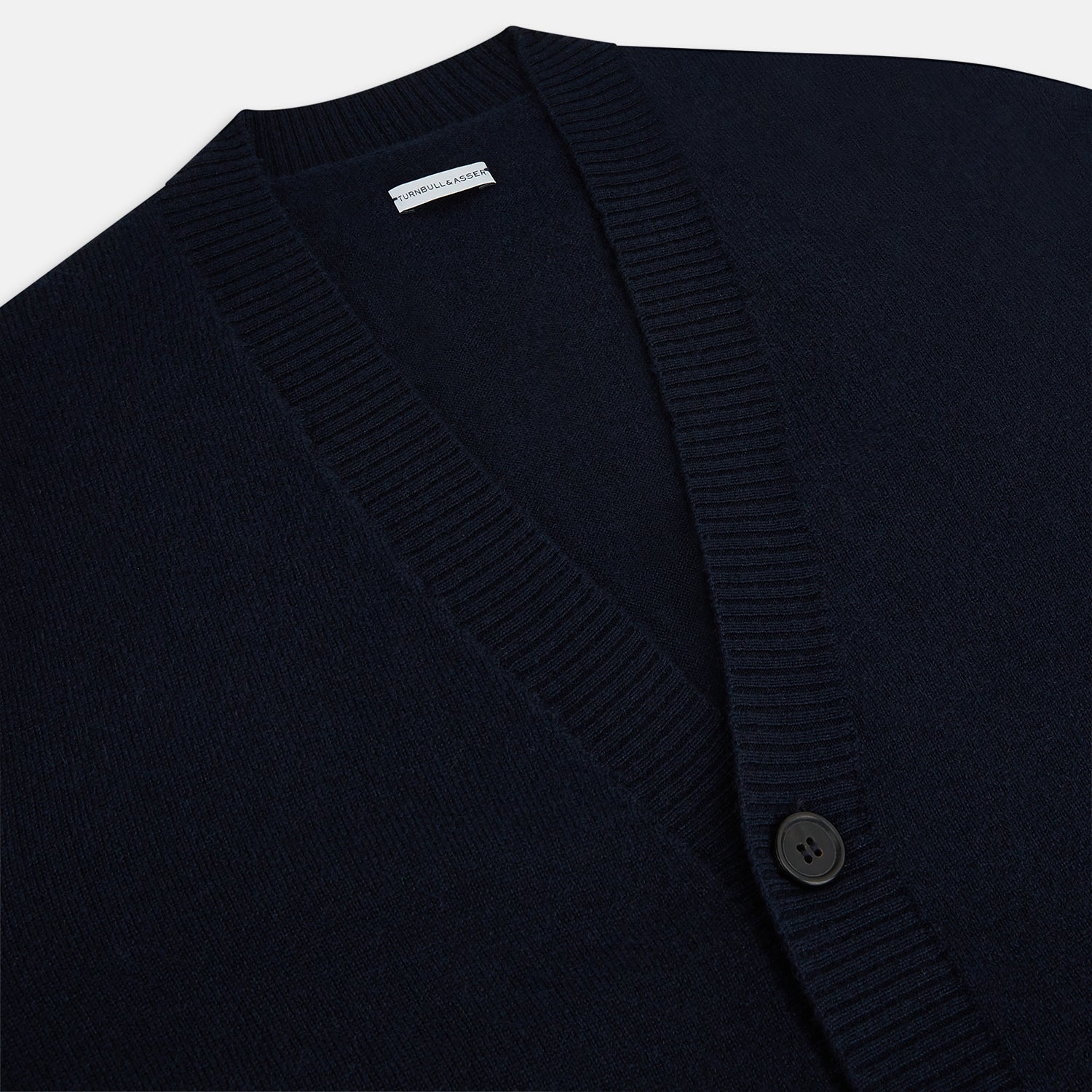 View 2 of product The Navy V-Neck Cashmere Cardigan by Turnbull & Asser features a button-up front, ribbed cuffs and hem, and two front pockets—a classic from our knitwear collection.