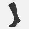 View 1 of product The image shows a single Turnbull & Asser Dark Steel/Navy Polka Dot Mid-Length Sock standing upright on a plain white background, featuring a ribbed cuff and a smooth, seamless finish.