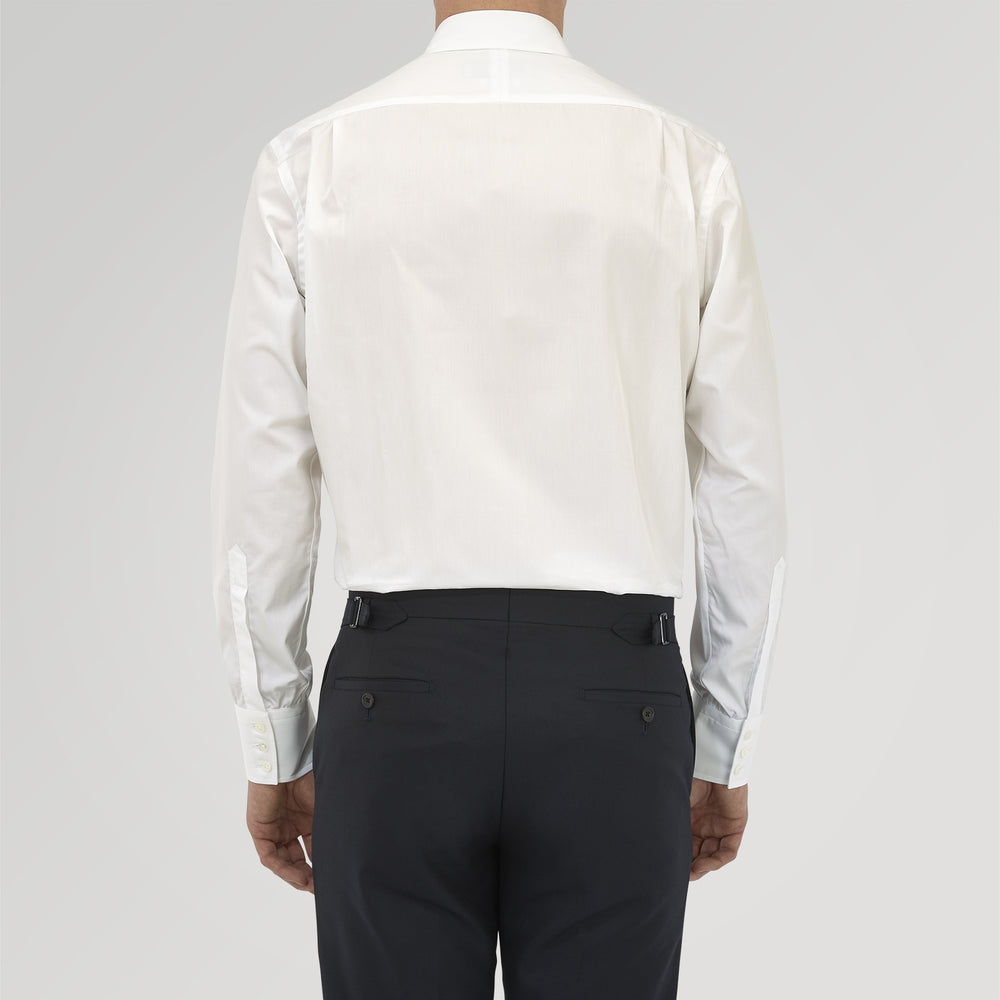 The Turnbull & Asser Tailored Fit Two-Fold 120 White Cotton Shirt features a Kent collar, double cuffs, and button-down front, displayed neatly folded against a light blue background.