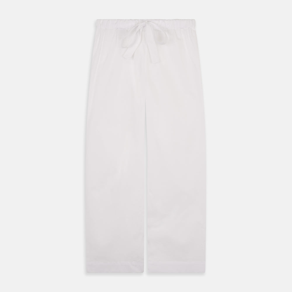 The Turnbull & Asser Women's Harriet Plain White Cotton Pyjama Set features long sleeves, black piping, a chest pocket, and matching pants with elastic waistband and ribbon tie, all displayed on a white background.