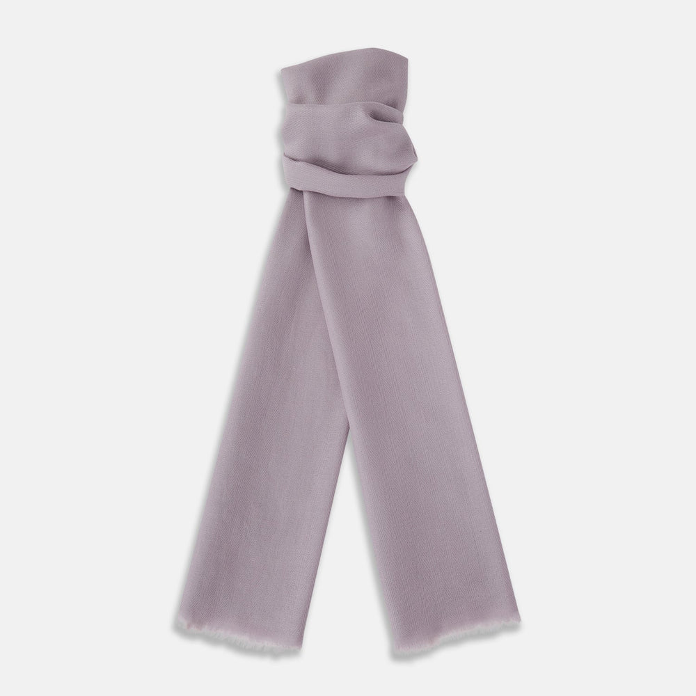 The Lilac Cashmere Scarf by Turnbull & Asser features a soft texture and unfinished, slightly frayed edges—an elegant accessory for any formal wardrobe.