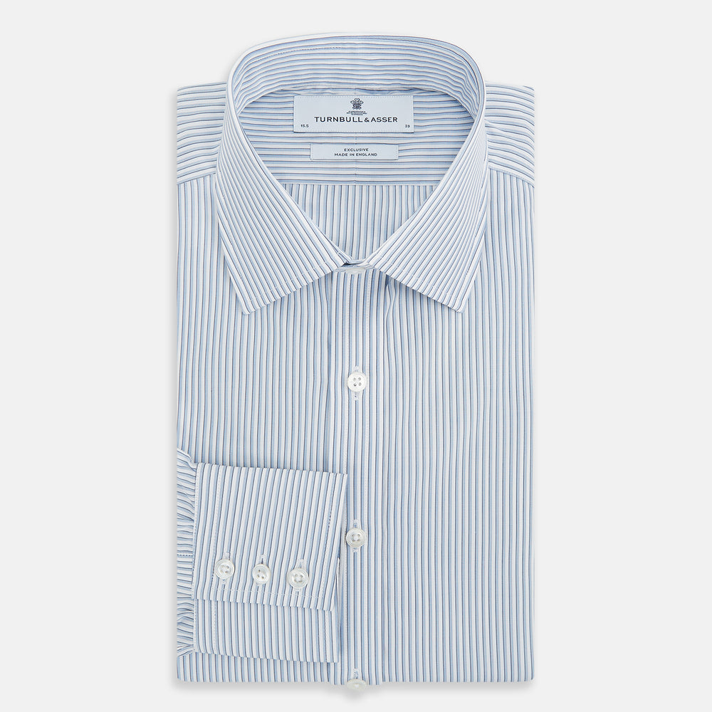The Turnbull & Asser Sky Blue Shadow Pinstripe Mayfair Shirt, a long-sleeved, button-up shirt with a T&A collar and light blue and white thin vertical stripes, is displayed flat on a white background.