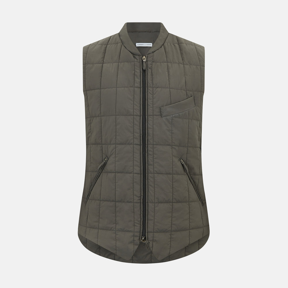 The Shadow Grey Quilted Gilet by Turnbull & Asser is a sleeveless, lightweight layer featuring a front zipper, two zippered side pockets, one chest pocket, and a rounded hem—shown on a plain white background.