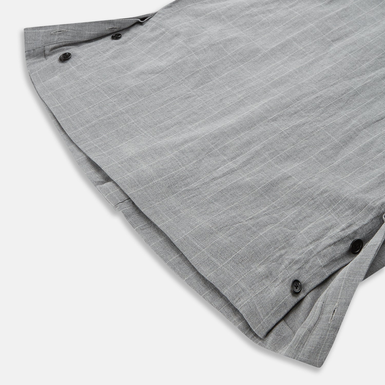 View 5 of product The Turnbull & Asser Grey Check Hampstead Overshirt features a light gray check pattern, pointed collar, chest pocket, and two zippered side pockets, displayed flat against a white background.