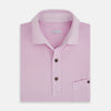 View 4 of product The Turnbull & Asser Pink Polo Shirt is a men's cotton polo with short sleeves, a collar, three dark buttons, and a chest pocket with a button, shown laid flat on a white background.
