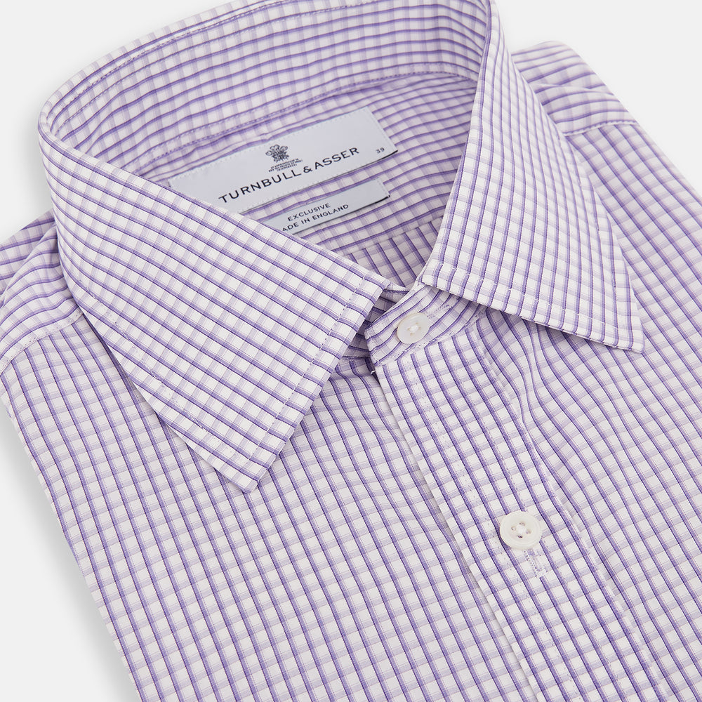 The Turnbull & Asser Purple Micro Shadow Check Mayfair Shirt features long sleeves, a classic collar, white buttons, and a subtle blue and white check pattern—perfect for formal wear and shown on a plain white background.