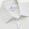 View 2 of product The Turnbull & Asser Yellow Multi Stripe Cotton Regular Fit Whitby Shirt features long sleeves, a classic collar, and thin yellow and blue stripes on white, displayed on a plain white surface.