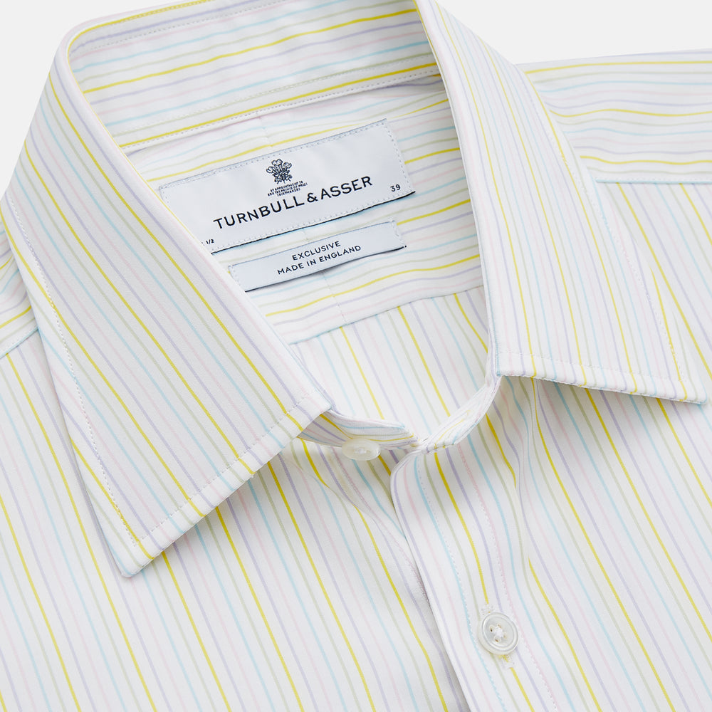 The Turnbull & Asser Yellow Multi Stripe Cotton Regular Fit Whitby Shirt features long sleeves, a classic collar, and thin yellow and blue stripes on white, displayed on a plain white surface.