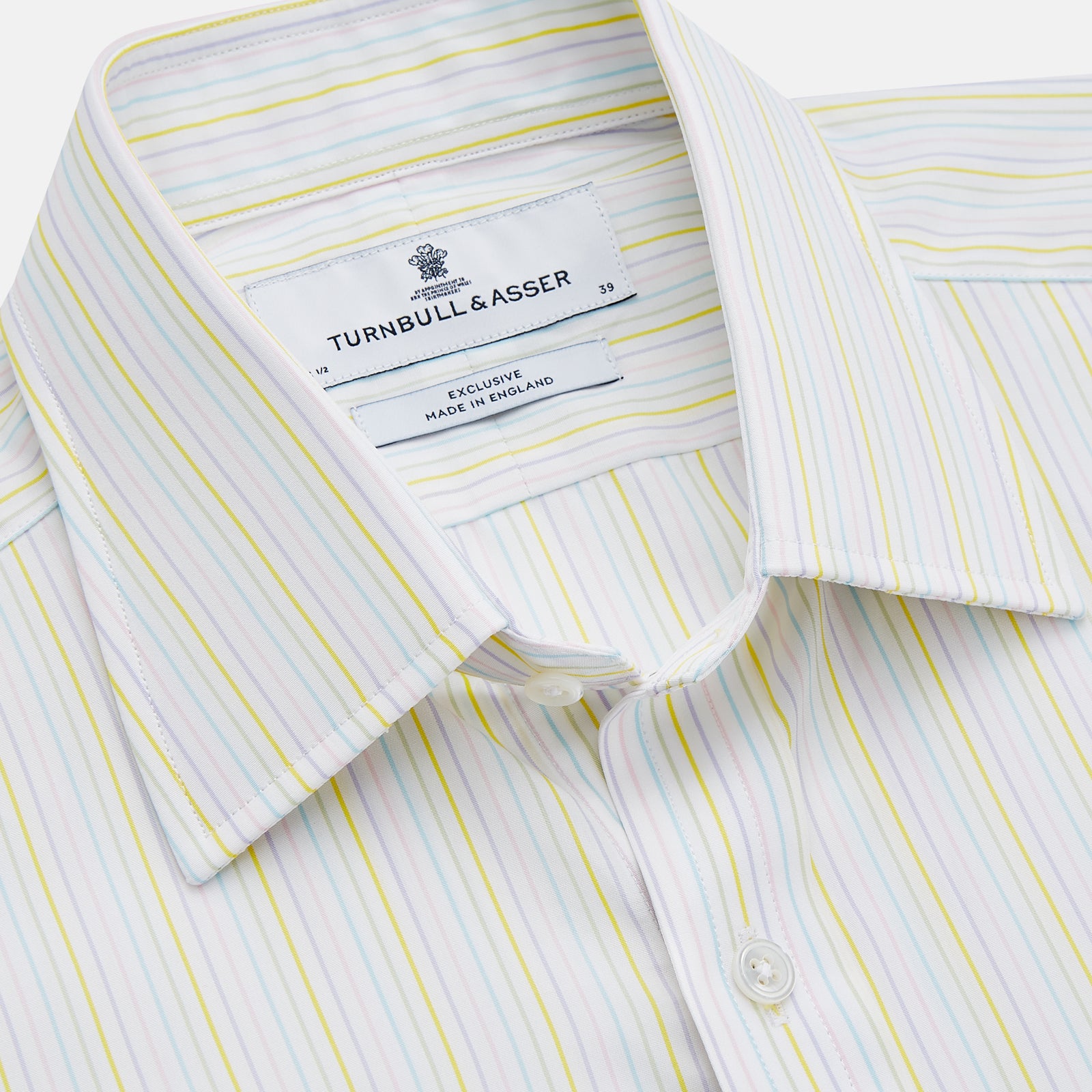 View 2 of product The Turnbull & Asser Yellow Multi Stripe Cotton Regular Fit Whitby Shirt features long sleeves, a classic collar, and thin yellow and blue stripes on white, displayed on a plain white surface.