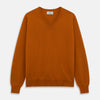 View 1 of product The Turnbull & Asser Rust Paden V-Neck Jumper, a pure cashmere sweater with long sleeves and ribbed cuffs and hem, is laid flat on a white background with the label visible at the neck.